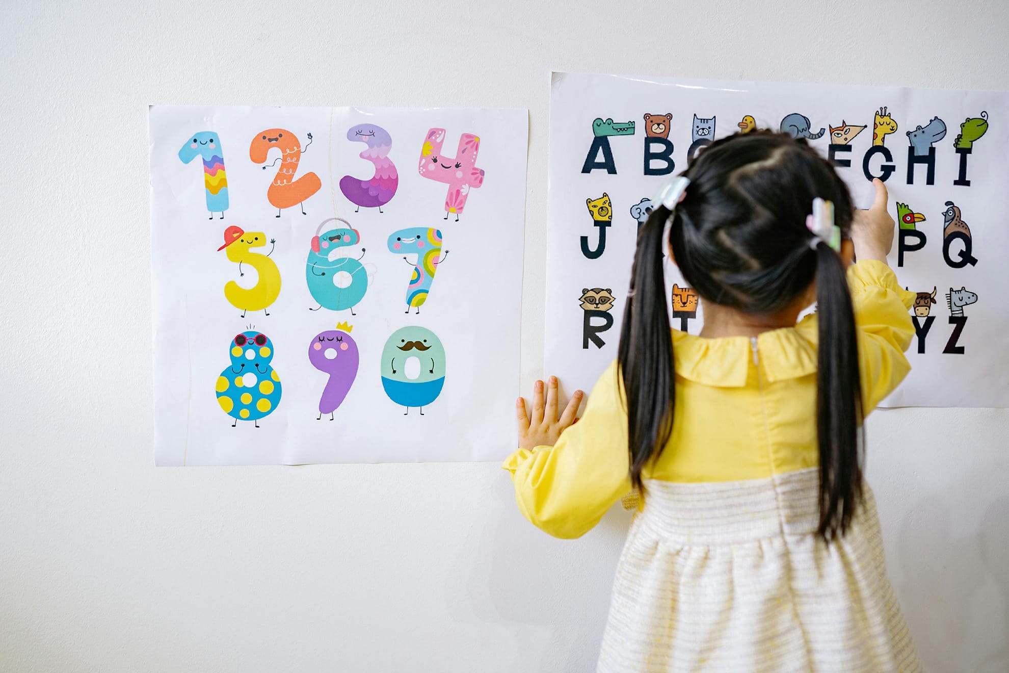 young girl learning numbers and ABCs