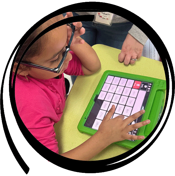 teacher working with a student using a keypad